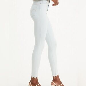 Levi's Women's Soft Blue Skinny Jeans with distressed bottoms Size 28